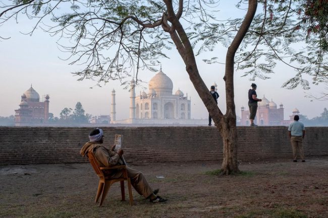 Khung cảnh vắng vẻ bên ngoài đền Taj Mahal, Ấn Độ lúc 5h sáng. Trung bình mỗi ngày có tới 10.000 – 15.000 khách tham quan ngôi đền và lượng người sẽ đông hơn vào cuối tuần. Từ 1/4/2018, chính quyền địa phương ra quy định mỗi người chỉ được tham quan ngôi đền tối đa 3 tiếng. Taj Mahal được xây dựng vào năm 1632, huy động tới 20.000 công nhân để xây dựng trong 20 năm. Ngôi đền là một trong bảy kỳ quan thế giới đương đại, nằm bên bờ sông Yamuna ở Agra, bang Uttar Pradesh. Lịch sử xây dựng Taj Mahal gắn liền với câu chuyện tình yêu của hoàng đế Shah Jahan (trị vì từ năm 1628 đến 1658) với người vợ Mumtaz Mahal. Ảnh: Ed Kashi, VII.