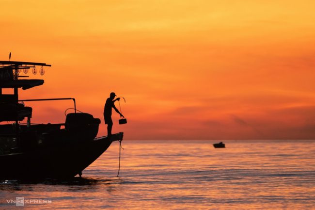Bức ảnh “Buổi sáng trên biển bình minh” ở huyện Thăng Bình, Quảng Nam ghi lại nhịp sống của ngư dân trên thuyền trong khung cảnh màu vàng cam lúc rạng sáng.